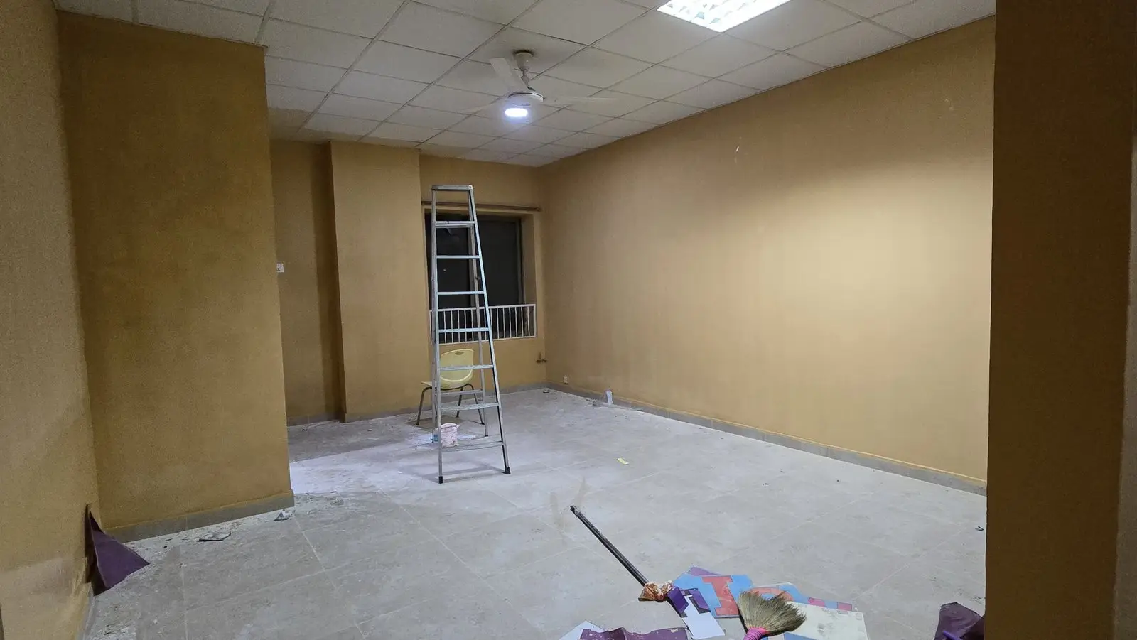 A classroom at the Umeed-e-Noor school being prepared, with fresh paint and an alphabet frieze on the wall.
